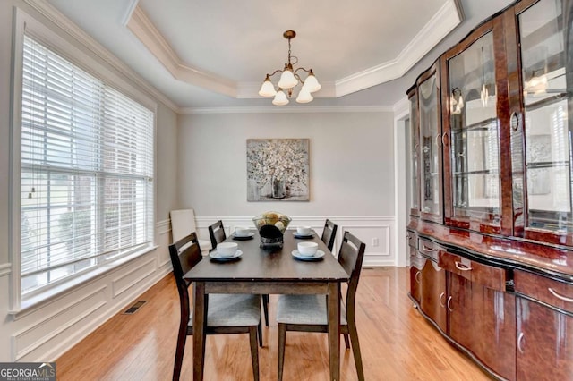475 Bayswater Way, Suwanee, GA 30024 - dining area with a chandelier, plenty of natural light, light wood finished floors, ornamental molding, and a wainscoted wall