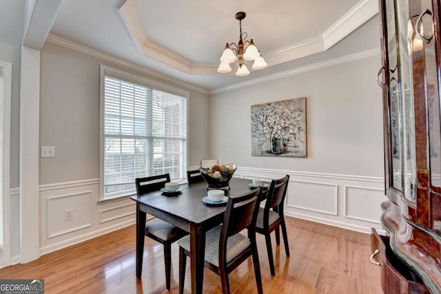 475 Bayswater Way, Suwanee, GA 30024 - dining area featuring a chandelier, light wood-style floors, ornamental molding, a wainscoted wall, and a decorative wall