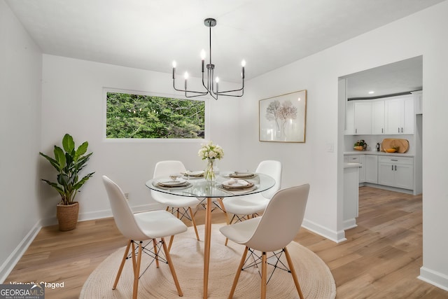 7455 Dover Ct, Riverdale, GA 30274 - dining space featuring light wood-type flooring, a chandelier, and baseboards