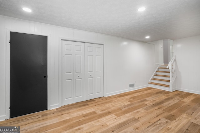 7455 Dover Ct, Riverdale, GA 30274 - below grade area featuring stairs, light wood finished floors, a textured ceiling, recessed lighting, and baseboards