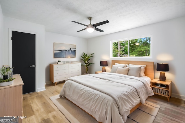 7455 Dover Ct, Riverdale, GA 30274 - bedroom featuring baseboards, light wood-type flooring, and ceiling fan