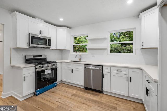 7455 Dover Ct, Riverdale, GA 30274 - kitchen with stainless steel appliances, a sink, recessed lighting, plenty of natural light, and white cabinets