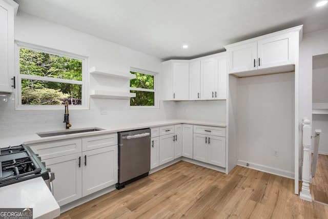7455 Dover Ct, Riverdale, GA 30274 - kitchen featuring stainless steel dishwasher, a sink, decorative backsplash, light wood-style floors, and white cabinets