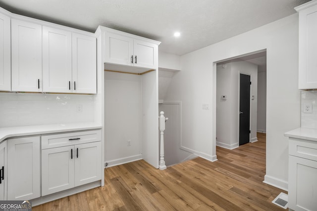 7455 Dover Ct, Riverdale, GA 30274 - kitchen with light countertops, white cabinets, baseboards, and recessed lighting