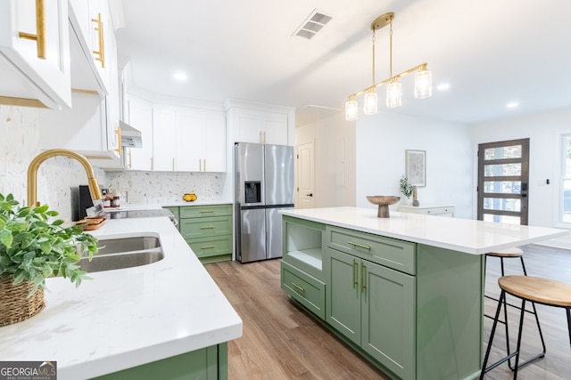 398 Baker Cir NW, Atlanta, GA 30318 - kitchen with green cabinets, stainless steel fridge with ice dispenser, white cabinetry, a breakfast bar, and recessed lighting
