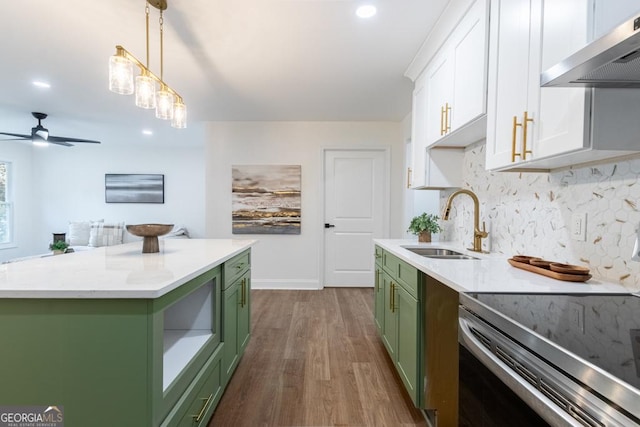 398 Baker Cir NW, Atlanta, GA 30318 - kitchen with green cabinetry, wall chimney range hood, a sink, stainless steel range with electric cooktop, and recessed lighting