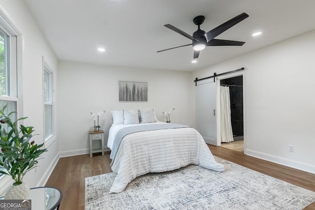 398 Baker Cir NW, Atlanta, GA 30318 - bedroom with a barn door, wood finished floors, baseboards, and recessed lighting