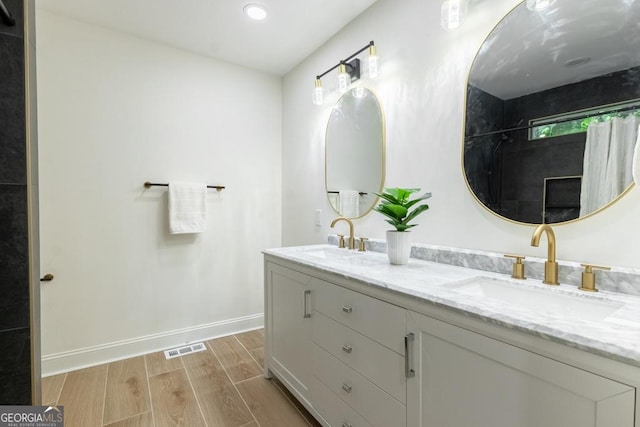 398 Baker Cir NW, Atlanta, GA 30318 - full bathroom featuring wood finished floors, double vanity, baseboards, a shower with curtain, and recessed lighting