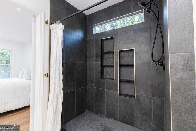 398 Baker Cir NW, Atlanta, GA 30318 - bathroom with ensuite bathroom, tiled shower, and wood finished floors
