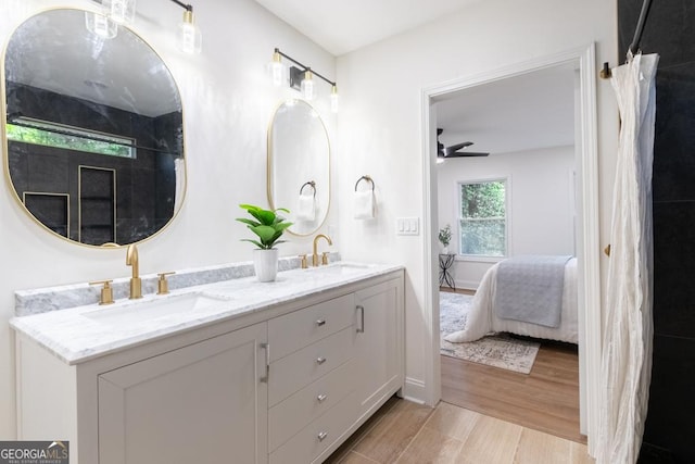 398 Baker Cir NW, Atlanta, GA 30318 - full bath with connected bathroom, double vanity, wood finished floors, and ceiling fan
