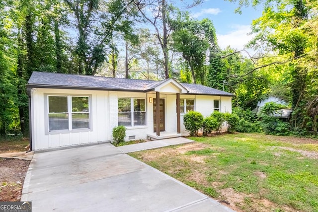 398 Baker Cir NW, Atlanta, GA 30318 - ranch-style home with board and batten siding, a front lawn, concrete driveway, and brick siding