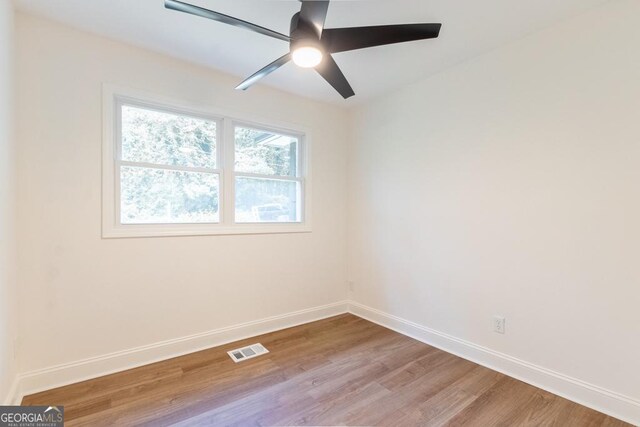 398 Baker Cir NW, Atlanta, GA 30318 - empty room with light wood finished floors, baseboards, and ceiling fan