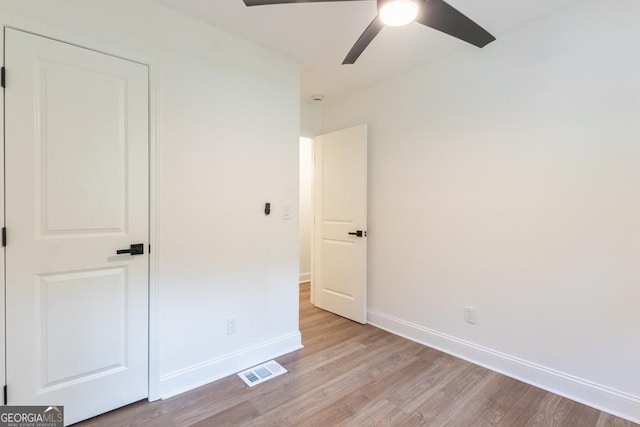 398 Baker Cir NW, Atlanta, GA 30318 - unfurnished bedroom with light wood-type flooring, baseboards, and a ceiling fan