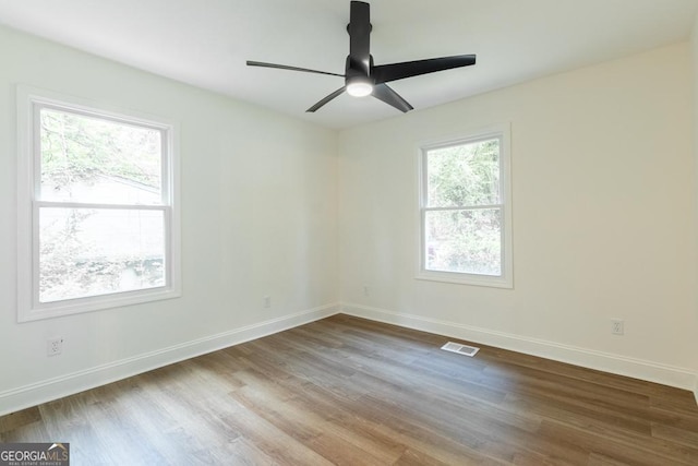 398 Baker Cir NW, Atlanta, GA 30318 - spare room featuring wood finished floors, baseboards, and ceiling fan