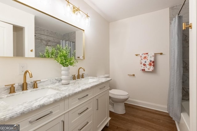 398 Baker Cir NW, Atlanta, GA 30318 - bathroom with double vanity, toilet, wood finished floors, baseboards, and shower / bathtub combination with curtain