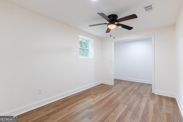 398 Baker Cir NW, Atlanta, GA 30318 - unfurnished room with light wood-type flooring, baseboards, and a ceiling fan