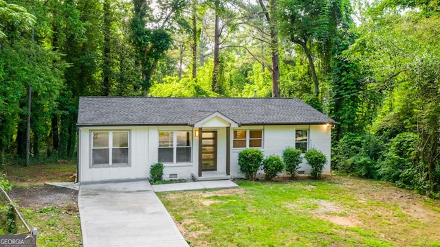 398 Baker Cir NW, Atlanta, GA 30318 - view of front facade with roof with shingles, brick siding, a front yard, and crawl space