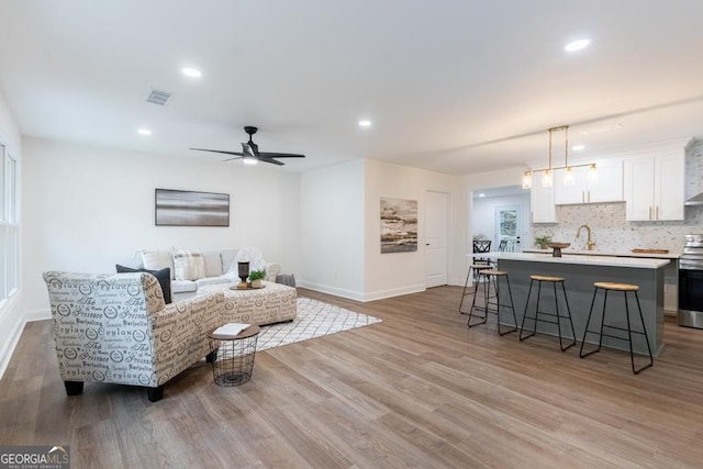 398 Baker Cir NW, Atlanta, GA 30318 - living area with wood finished floors, baseboards, recessed lighting, and a ceiling fan