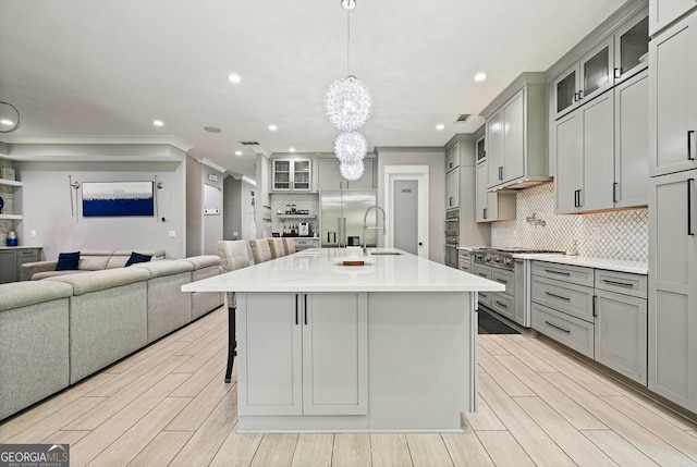 2804 Skyland Dr NE, Brookhaven, GA 30341 - kitchen featuring gray cabinets, open floor plan, a sink, recessed lighting, and decorative backsplash