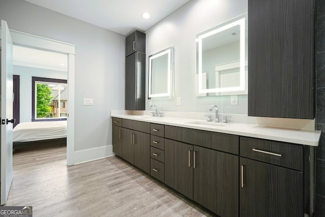 2804 Skyland Dr NE, Brookhaven, GA 30341 - bathroom with wood finished floors, double vanity, baseboards, ensuite bath, and recessed lighting