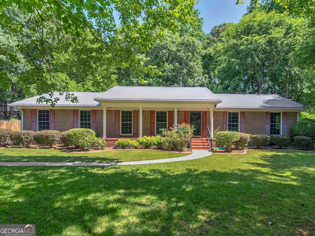 141 Mckinley Dr, Griffin, GA 30224 - ranch-style home with brick siding, a front yard, a porch, and metal roof
