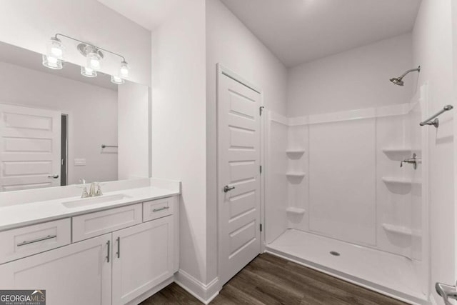554 Creek Rd, Cornelia, GA 30531 - bathroom with wood finished floors, vanity, a shower, and baseboards