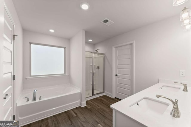 554 Creek Rd, Cornelia, GA 30531 - bathroom featuring a bath, wood finished floors, a shower stall, double vanity, and recessed lighting