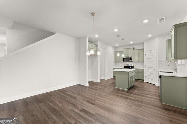 325 Magnolia Villas Dr, Cornelia, GA 30531 - kitchen with green cabinets, a sink, stainless steel appliances, a kitchen island, and baseboards