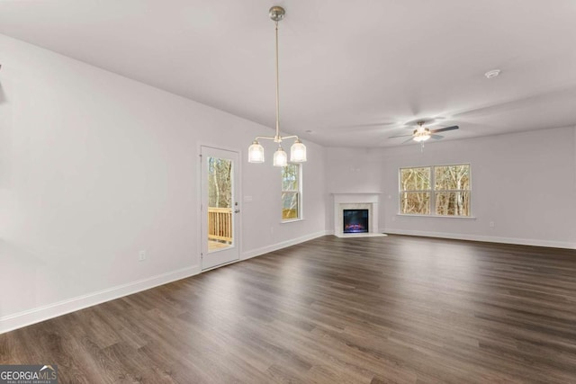 325 Magnolia Villas Dr, Cornelia, GA 30531 - unfurnished living room featuring healthy amount of natural light, dark wood-type flooring, and a high end fireplace