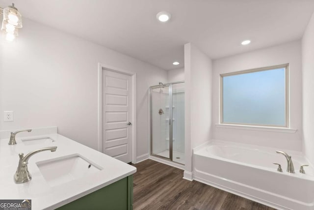 325 Magnolia Villas Dr, Cornelia, GA 30531 - bathroom featuring a garden tub, a shower stall, wood finished floors, recessed lighting, and double vanity