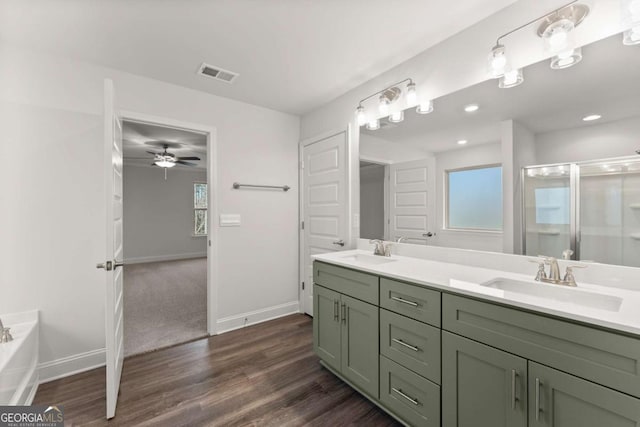 325 Magnolia Villas Dr, Cornelia, GA 30531 - bathroom featuring double vanity, wood finished floors, baseboards, a shower stall, and ceiling fan