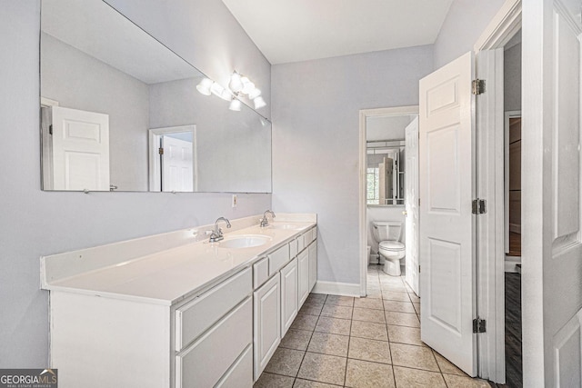2701 Log Cabin Dr SE, Atlanta, GA 30339 - full bath featuring double vanity, toilet, tile patterned floors, and baseboards