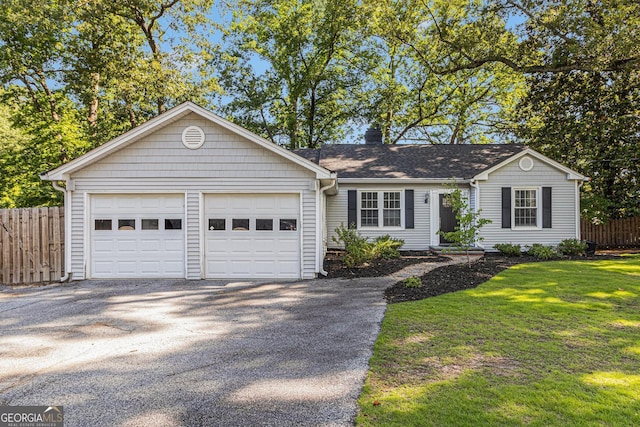 2701 Log Cabin Dr SE, Atlanta, GA 30339 - ranch-style home featuring asphalt driveway, an attached garage, a chimney, and a shingled roof