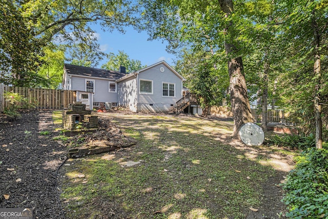 2701 Log Cabin Dr SE, Atlanta, GA 30339 - rear view of property featuring a fenced backyard, stairs, a deck, and a chimney
