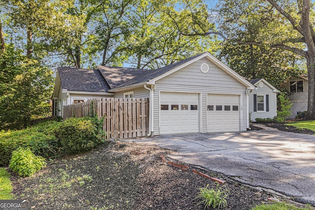 2701 Log Cabin Dr SE, Atlanta, GA 30339 - view of front of home featuring an attached garage, driveway, and a shingled roof