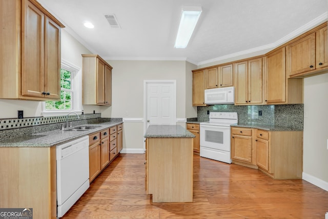 1315 Crane Ct, Mcdonough, GA 30252 - kitchen with white appliances, a sink, dark stone countertops, a center island, and crown molding