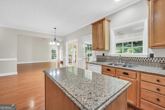 1315 Crane Ct, Mcdonough, GA 30252 - kitchen with a sink, dishwasher, a kitchen island, a chandelier, and light wood-style floors