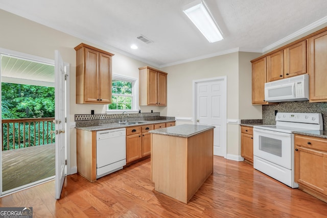 1315 Crane Ct, Mcdonough, GA 30252 - kitchen with white appliances, a sink, crown molding, a center island, and tasteful backsplash