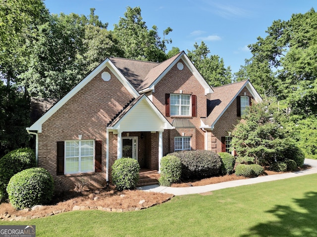 1315 Crane Ct, Mcdonough, GA 30252 - view of front of home with brick siding, a front yard, and a porch