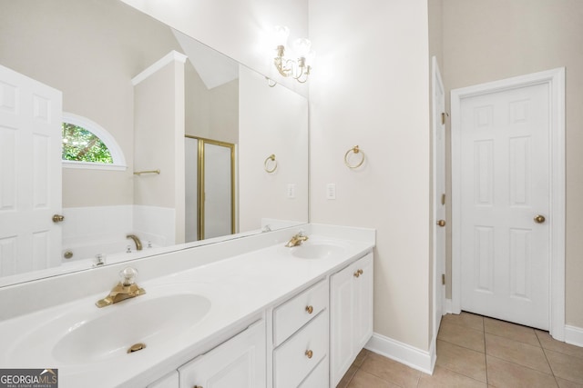 1315 Crane Ct, Mcdonough, GA 30252 - bathroom featuring tile patterned flooring, a shower stall, double vanity, a garden tub, and baseboards