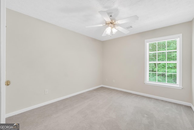 1315 Crane Ct, Mcdonough, GA 30252 - spare room featuring light colored carpet, baseboards, a ceiling fan, and a textured ceiling