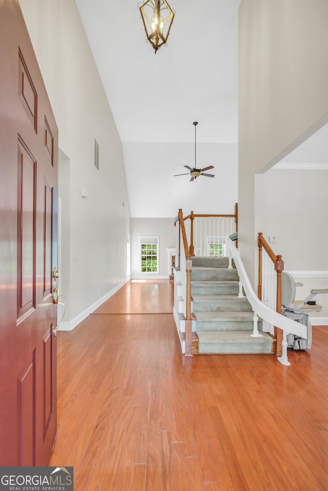 1315 Crane Ct, Mcdonough, GA 30252 - entrance foyer featuring high vaulted ceiling, stairs, light wood-style floors, a ceiling fan, and baseboards