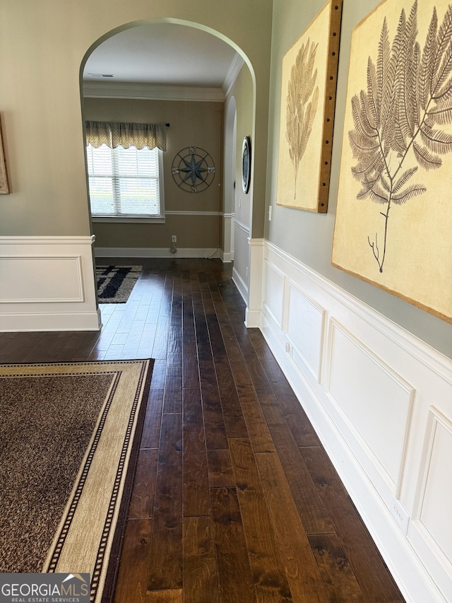 1869 Schofield Dr, Hampton, GA 30228 - corridor with dark wood finished floors, crown molding, arched walkways, wainscoting, and a decorative wall