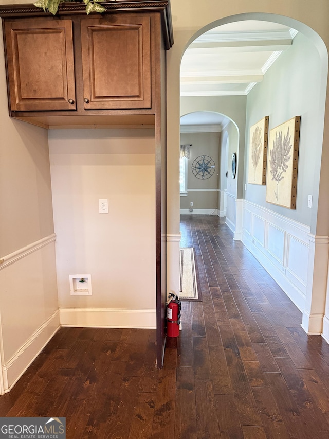 1869 Schofield Dr, Hampton, GA 30228 - hall featuring ornamental molding, dark wood finished floors, arched walkways, a wainscoted wall, and a decorative wall
