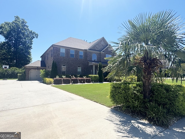 1869 Schofield Dr, Hampton, GA 30228 - view of front of property featuring driveway, a front yard, and brick siding