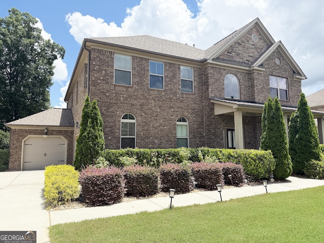 1869 Schofield Dr, Hampton, GA 30228 - view of front facade featuring brick siding, a garage, and driveway