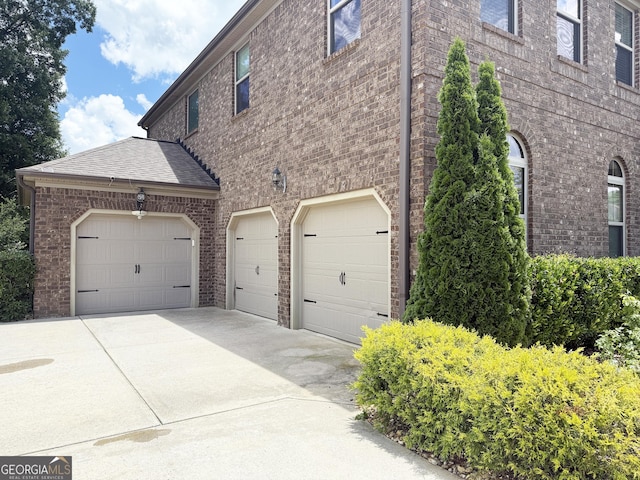 1869 Schofield Dr, Hampton, GA 30228 - view of home's exterior with brick siding, concrete driveway, and an attached garage