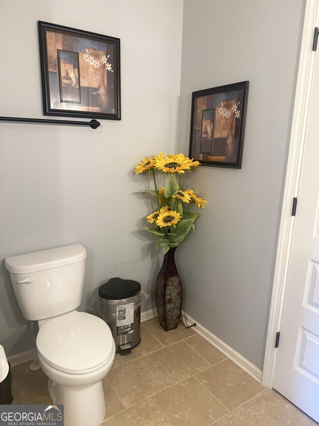 1869 Schofield Dr, Hampton, GA 30228 - half bathroom with toilet, baseboards, and tile patterned flooring