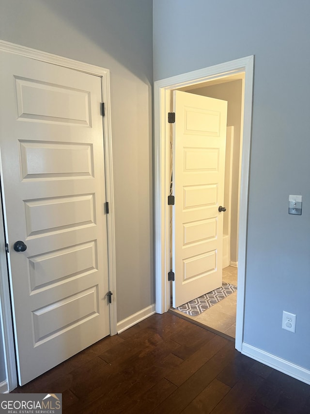 1869 Schofield Dr, Hampton, GA 30228 - hall featuring dark wood finished floors and baseboards