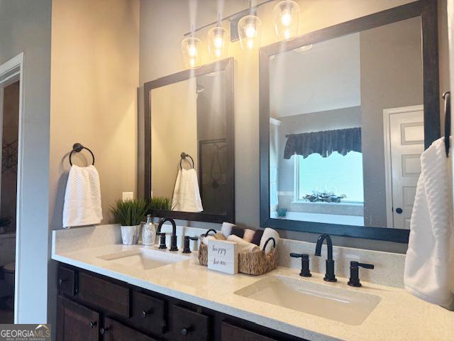 1869 Schofield Dr, Hampton, GA 30228 - full bathroom featuring double vanity and toilet